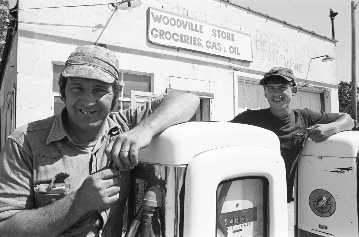 Chris and Les Swiger man the pumps at the Woodville Store and gas station, Woodville; 1976.Guide to Michigan;.
