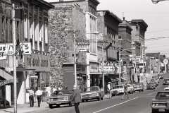 Downtown buildings are left from the mining and lumbering boom of a previous century, Houghton; 1976.Guide to Michigan; 1976.