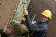 Firefighters  practice rappelling off Ellar Building; 1997.