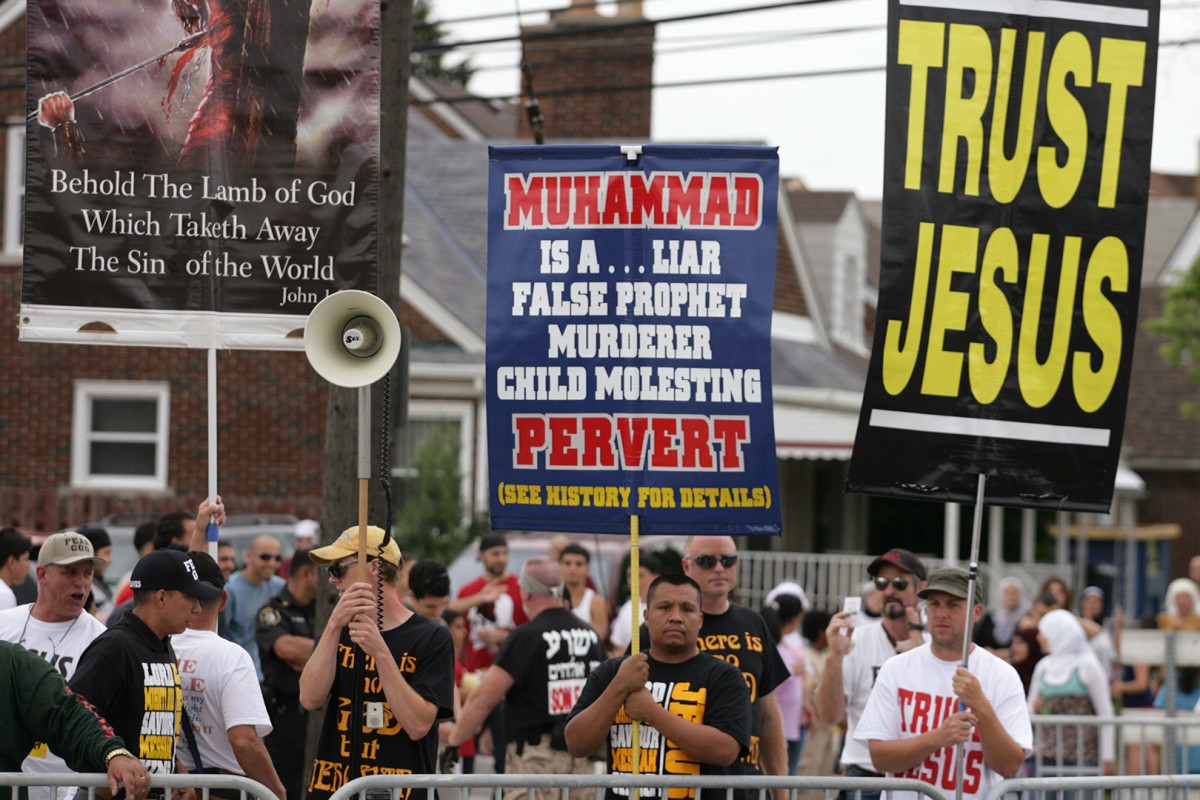 ArabInt11Fest004:	 Members of the Christian group called Bible Believers display offensive signs and scream at the crowd at the Arab International Festival Friday.