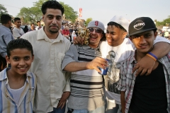 AI06Fest104:       	Friends Mohammed Elhaj, Abdulgbar Elhaj, Ali Alderwish, Ahmed Alsaadi and Waleed Ammari celebrate Alderwish’s winning a stuffed tiger at a carnival game at the Arab International Festival Friday.