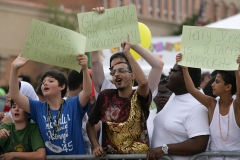 ArabInt11Fest022:	 Visitors to the Arab International Festival hold up impromptu signs at a Christian group called Bible Believers Friday. The group shouted insults at residents and carried large offensive signs.