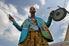 ArabInt2010Fest27:    	Stilt man Ric Roc Zoo bangs a gong to attract people to the Children’s’ Tent at the 15th Annual Arab International Festival last year.