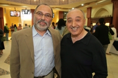 ACCESS Executive Director Hassan Jaber and former Director Ismael Ahmed greet each other at the opening of a photo exhibit of Concert of Colors performances June 4.