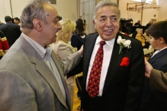 Michael Berry is congratulated by ACCESS executive director Ismael Ahmed and others upon his arrival at the dedication ceremony April 26 for the Michael Berry Career Center that is named for him.